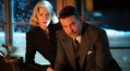 Cate Blanchett and Bradley Cooper look into the camera in a still from Nightmare Alley.