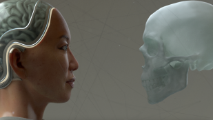 A female robot's head looks at an artificial human skull