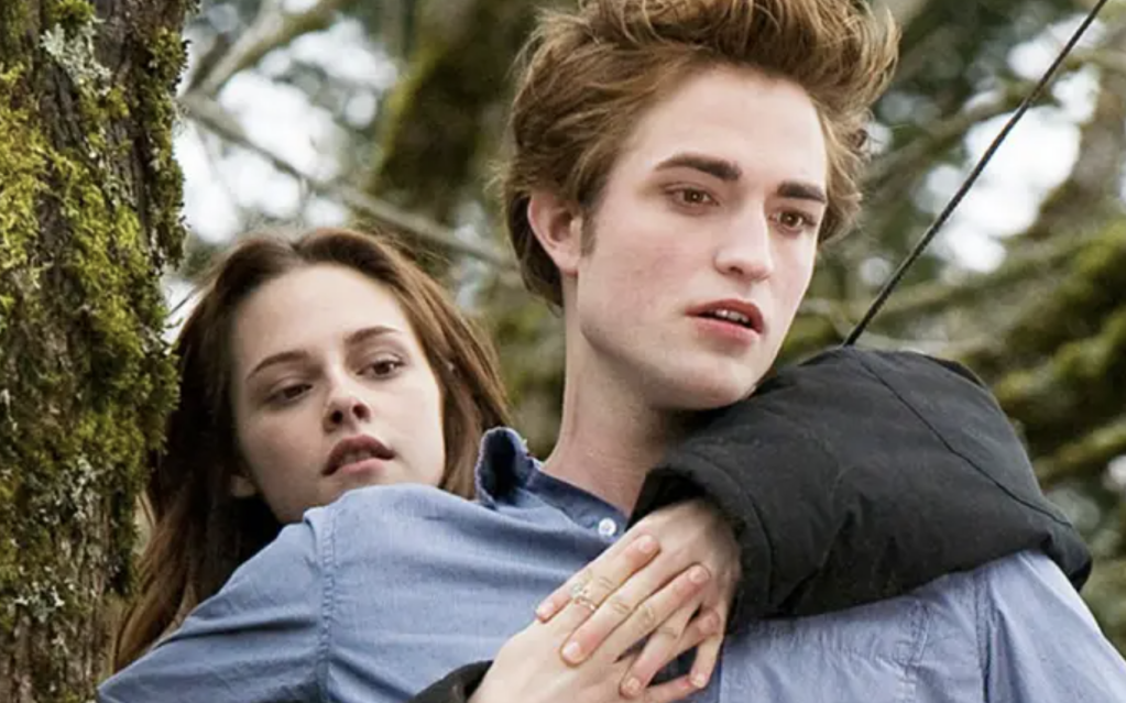 Kirsten Stewart and Robert Pattinson take to the trees in Twilight. Summit Entertainment.