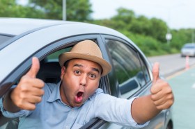 Surprised,Young,Asian,Man,Sitting,In,Car,Doing,Double,Thumb