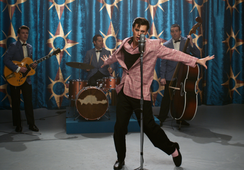 Actor performing Elvis on stage