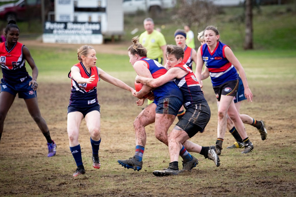 Action shot: members of the Mt Alexander Falcons football club playing a game of football.