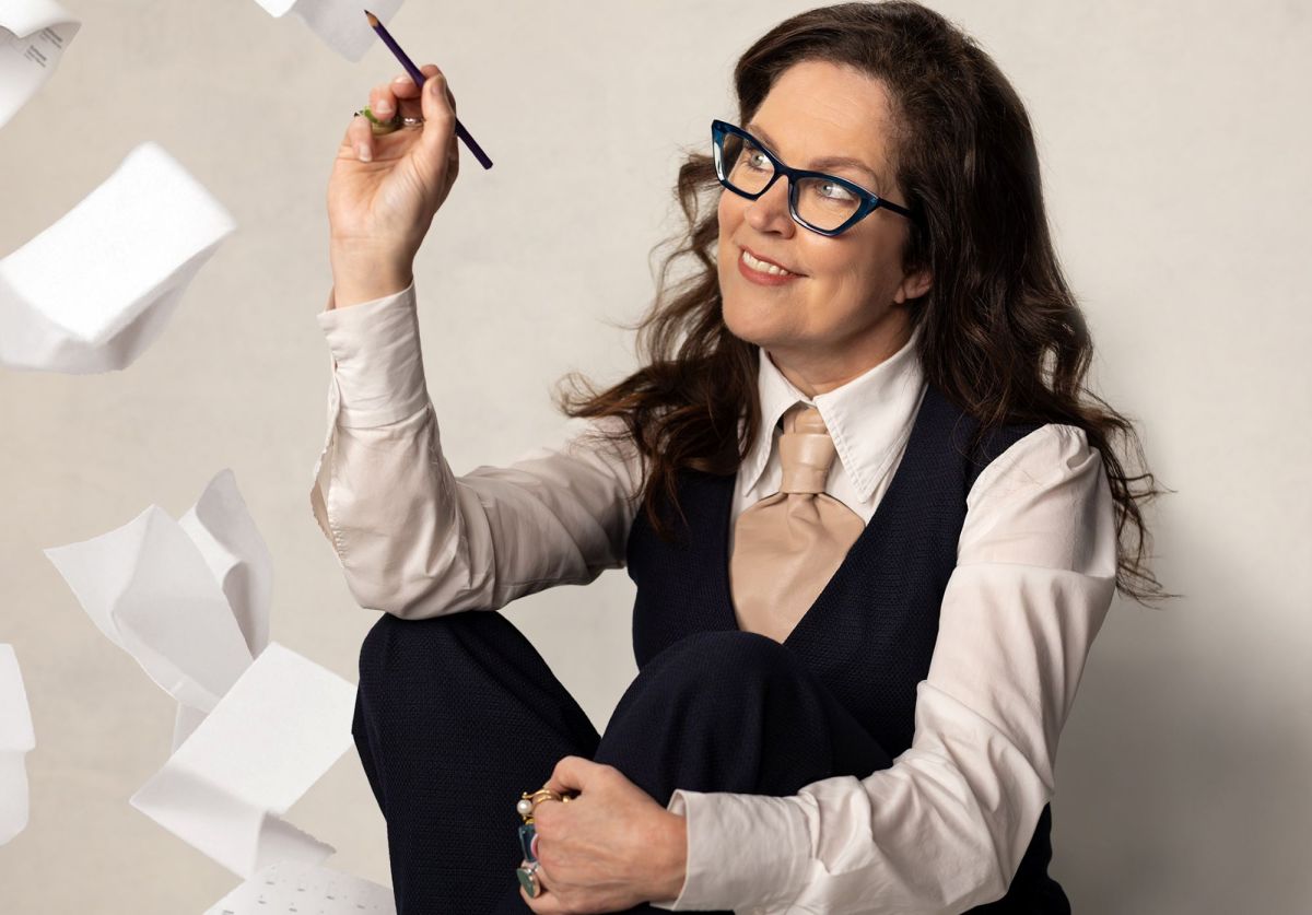'Annabel Crabb's Civic Duty' starts Monday 10 November on ABC1. A fair-skinned woman with dark hair and dark framed glasses sits holding a pencil as voting forms flutter down around her.