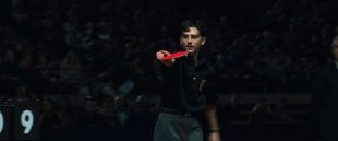 Marty Supreme. The titular character, played by Timothée Chalamet, is pictured holding a red table tennis racquet and pointing towards an off-screen opponent. Stan.