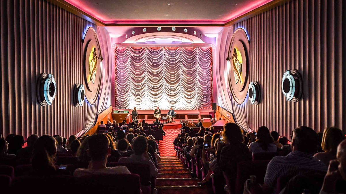 A screening at the Alliance Française French Film Festival. The photo depicts rows of audience members in seats and the screen behind them.